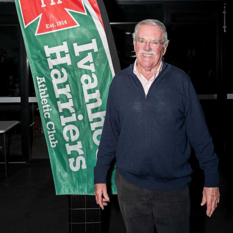 Jeff standing in font of Ivanhoe Harriers banner